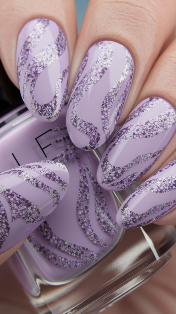 Artistic nails with swirling silver and purple glitter patterns over a lavender base.
