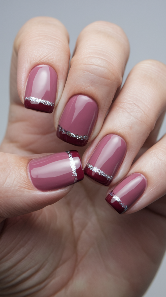 Winter-themed nails with frosted white tips and silver glitter in a gradient effect.
