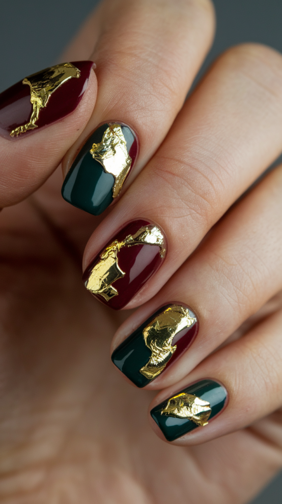 Rich red nails with gold foil accents, creating a glamorous, metallic sheen perfect for the holiday season