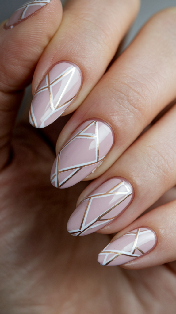 Minimalist pink nails with sharp white and gold geometric lines, creating a trendy, modern design