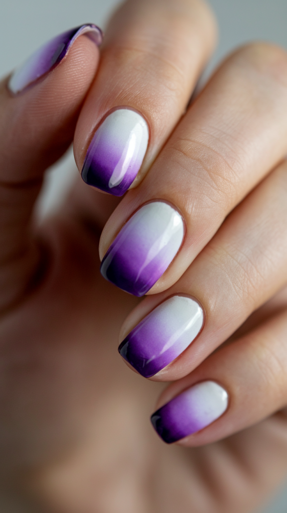 Gradient nails transitioning from deep violet tips to pure white at the base.
