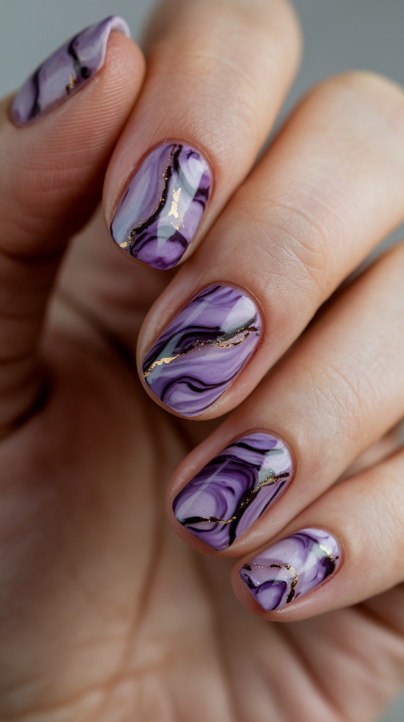 Swirls of dark and light purples creating a marble effect on glossy nails.
