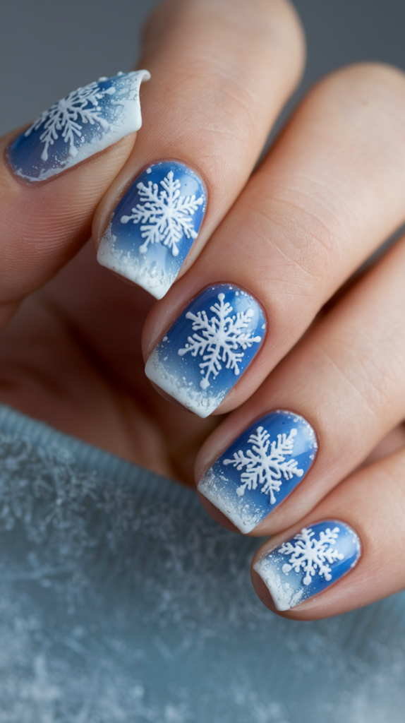 Ice blue nails with intricate white snowflake designs, inspired by the movie Frozen for a magical winter look