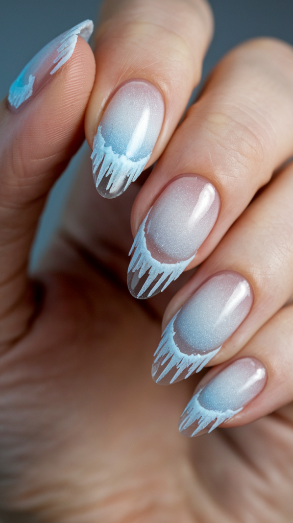 Light blue nails with frosty icicle details at the tips, creating a wintry, shimmering effect