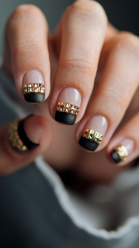 Minimalist chic black nail accented with a single gold stud, embodying simplicity and elegance