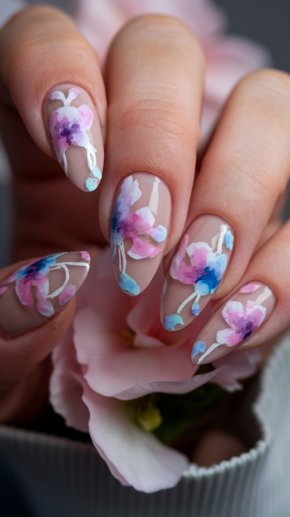 Watercolor-inspired floral acrylic nails with soft pink and lavender flowers, delicately painted to create a romantic and dreamy effect.

