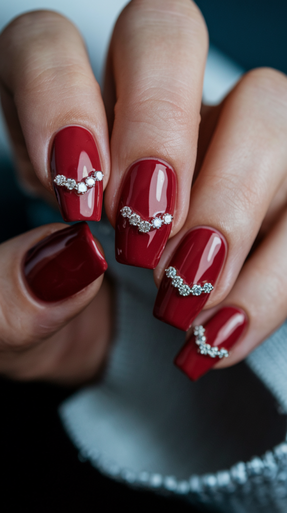 Classic red acrylic nails with small diamond studs, showcasing a timeless and glamorous design perfect for special occasions.

