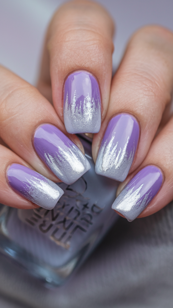 Cool and classy nails transitioning from soft lavender to frosty silver tips, giving a refreshing winter feel.