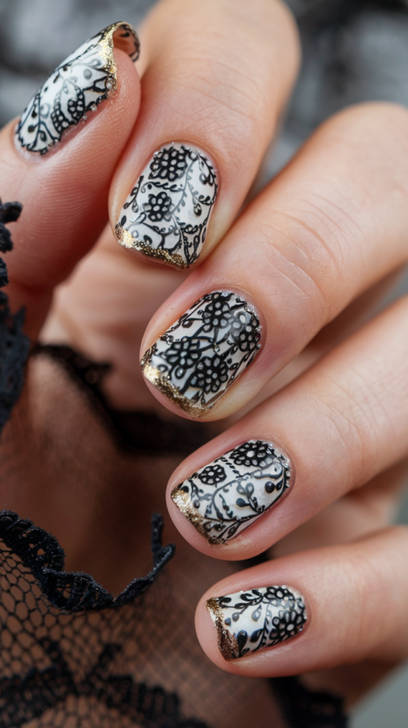 Elegant lace designs in black with gold edges, creating a sophisticated pattern on nails