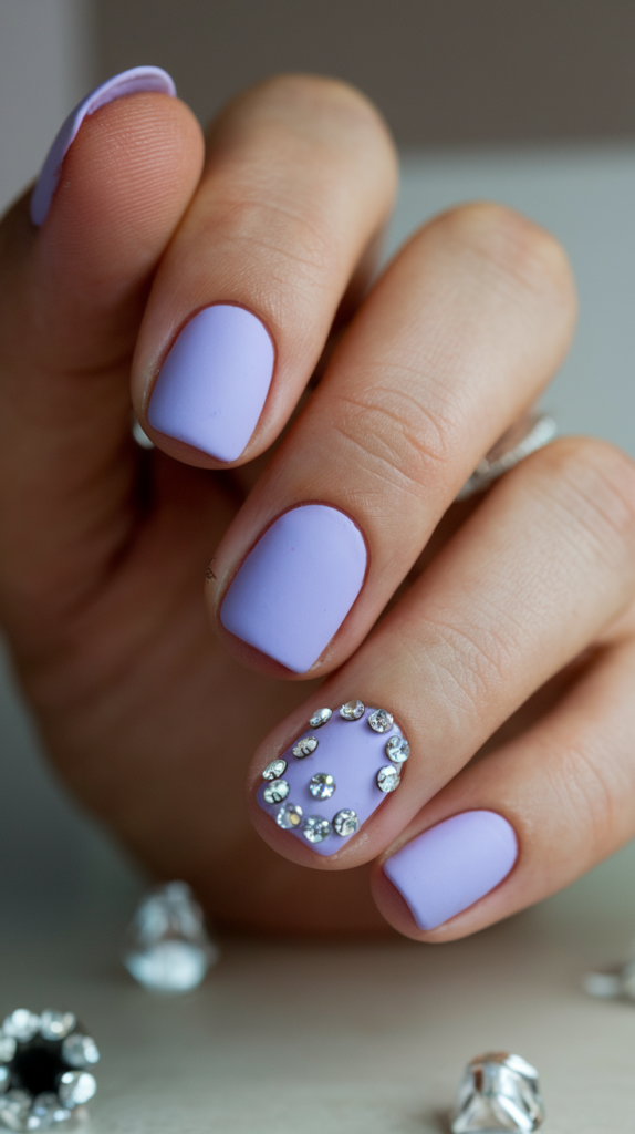 Matte Lavender with Rhinestones – Matte lavender nails with small, clear rhinestones at the cuticles for a subtle, glamorous touch