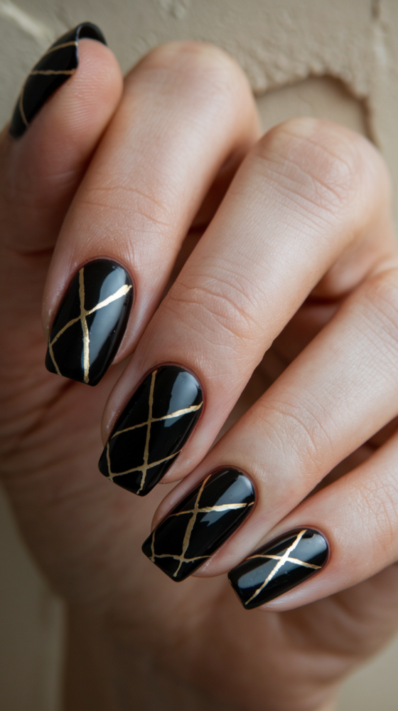 High-gloss black nails featuring thin golden linear designs, offering a sleek and polished Art Deco look.
