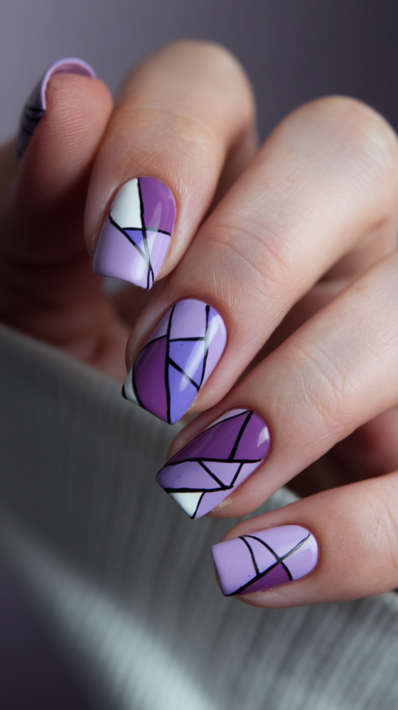 Geometric Purple Art Nails – Nails with various shades of purple in sharp geometric shapes, creating a minimalist and modern style