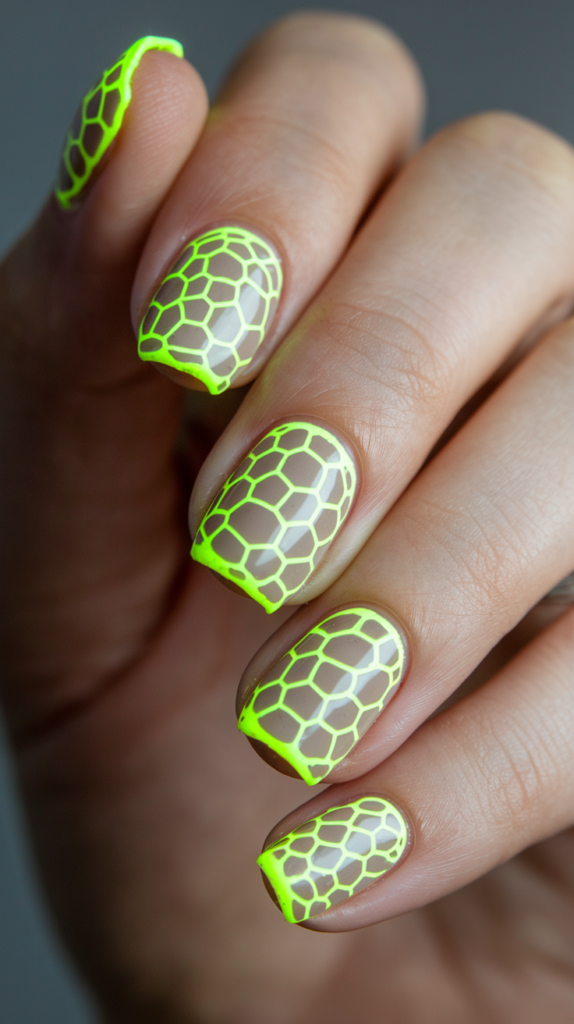 Neon checkerboard nail design with alternating green and pink squares on black