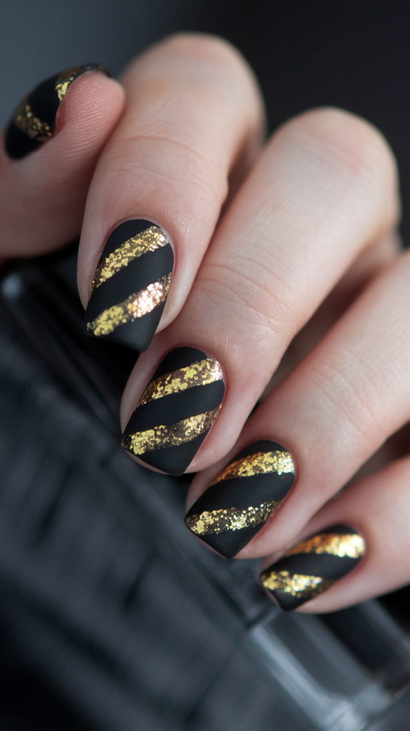 Matte black nails with thin gold glitter stripes arranged in clean, straight lines, offering a chic and vintage-inspired Art Deco look.
