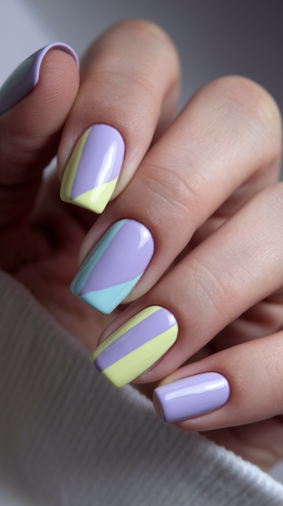 Pastel Color-Blocked Nails – Nails divided into sections painted with lavender, pale yellow, and light blue, offering a retro-inspired color-blocked design