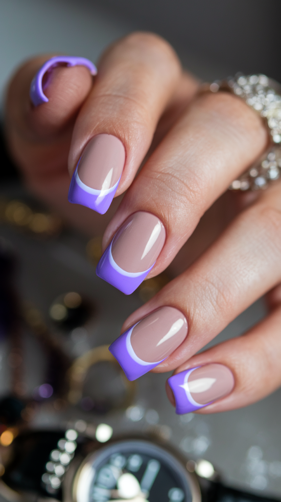 Purple French Tip Nails – Nude-based nails with bright lilac French tips, adding a colorful twist to a classic manicure