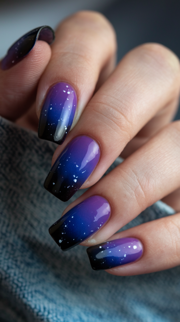 Midnight Purple Gradient Nails – Dark purple nails transitioning into deep blue at the tips, with tiny white speckles creating a cosmic, night-sky effect