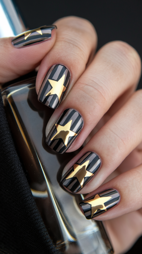 Black or navy nails with metallic gold stars and stripes for a sleek, modern design.
