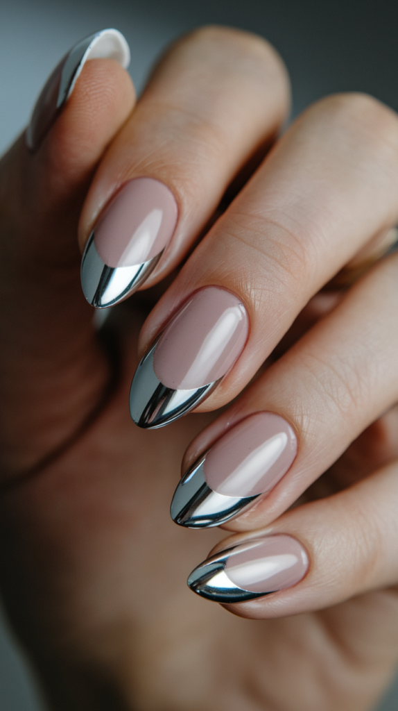 French manicure with shiny silver chrome tips and a soft pink nude base.