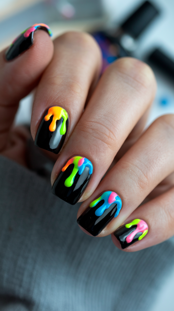 Nails with thick, dripping paint designs in vivid colors running down from the cuticle area on a glossy black base