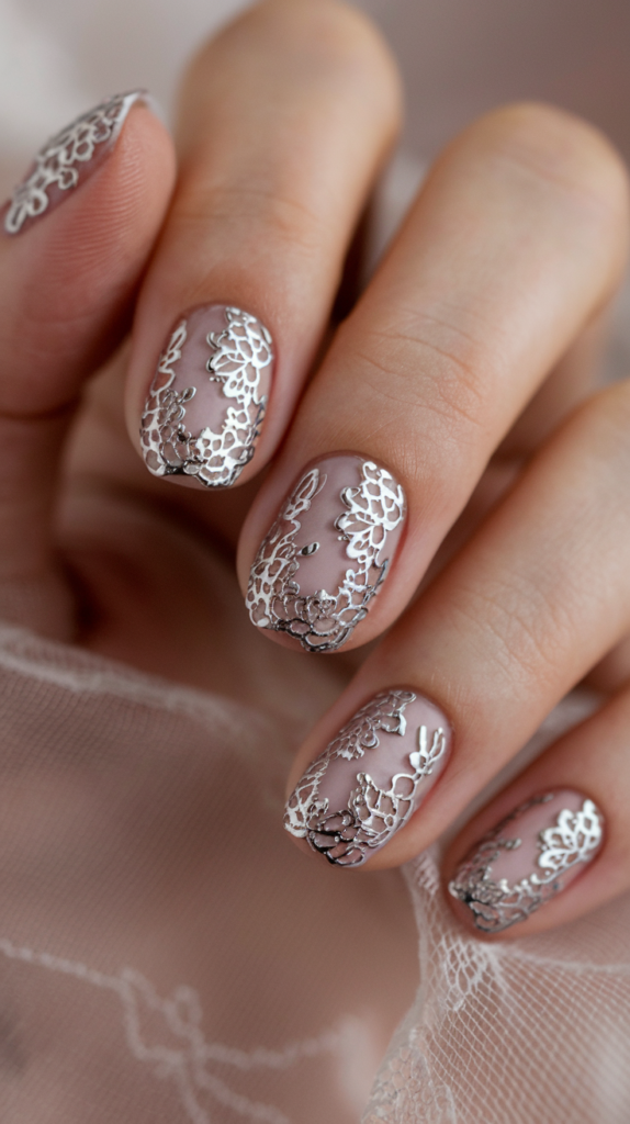 Delicate lace patterns in chrome over a soft nude base for a romantic and elegant vibe