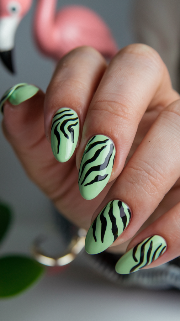 Light green nails with bold black zebra stripes