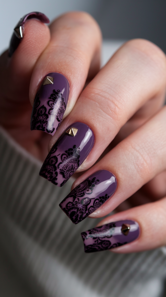 Black and Purple Gothic Nails – Dark purple nails with intricate black lace patterns and metallic studs for an edgy gothic vibe