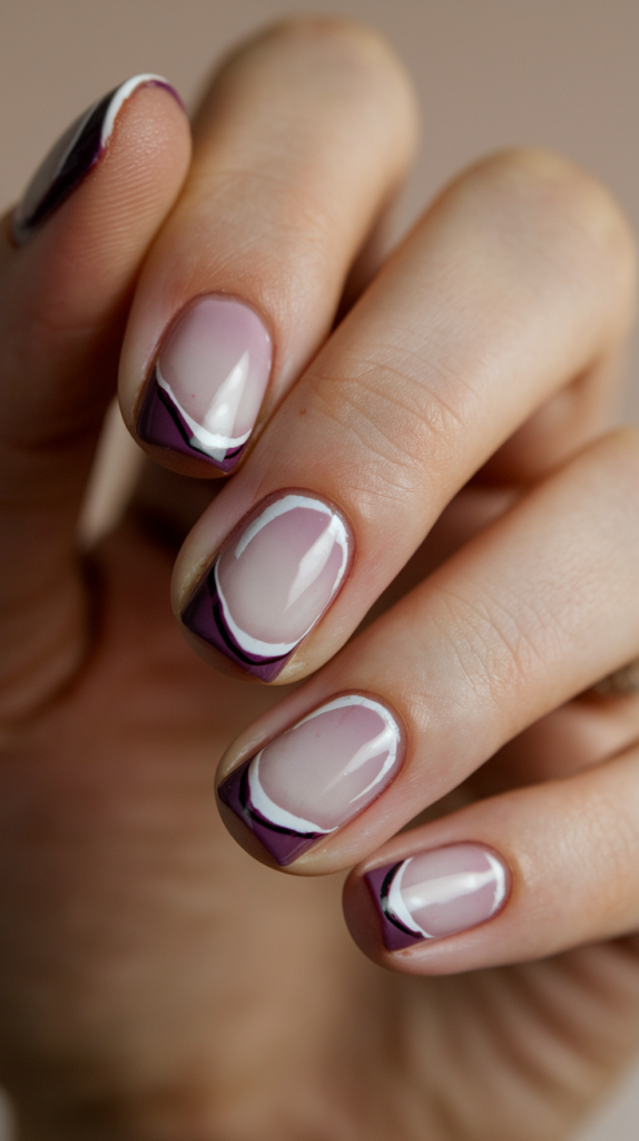 Reverse French with Dark Purple Base – Dark plum nails with a nude crescent near the cuticle, creating an elegant reverse French effect