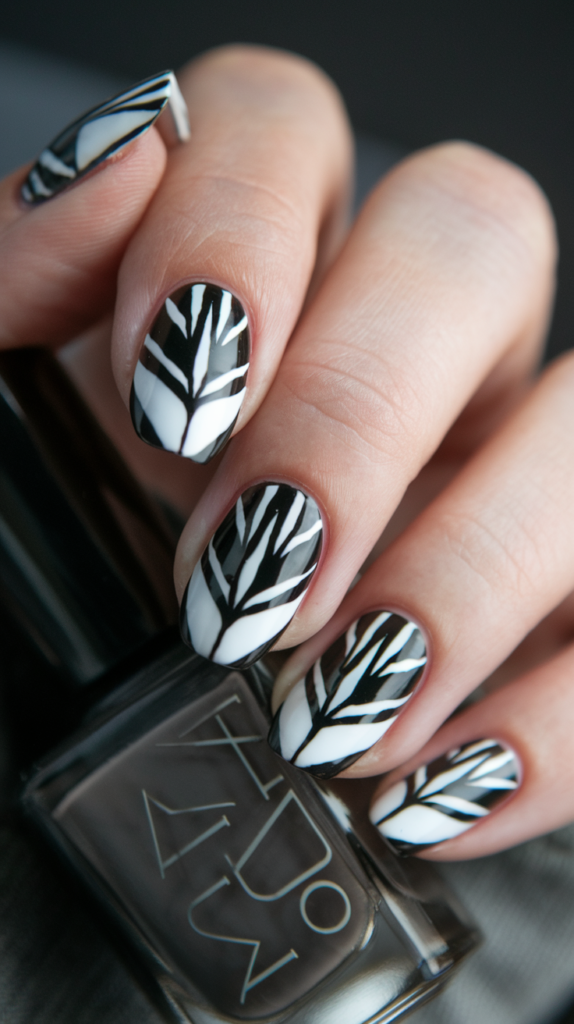 Black and white nails mimicking a tuxedo pattern, complete with small black buttons and bow tie details for a playful, formal look.
