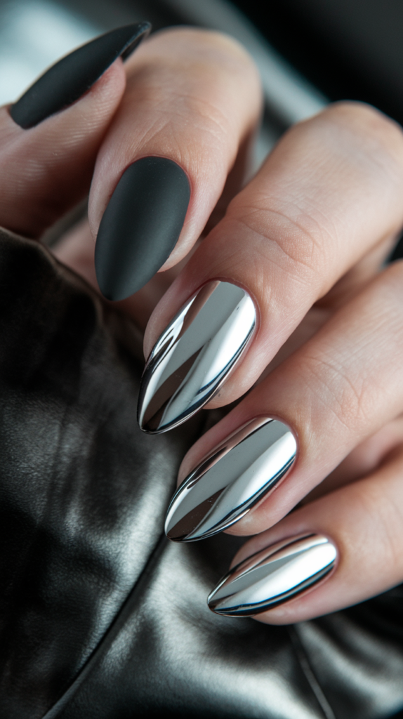 Nails featuring a mix of matte black with silver chrome accents for a textured, modern finish.

