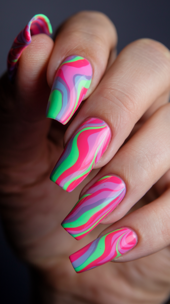 Neon swirl nail design with pink, green, and purple flowing lines on glossy nails