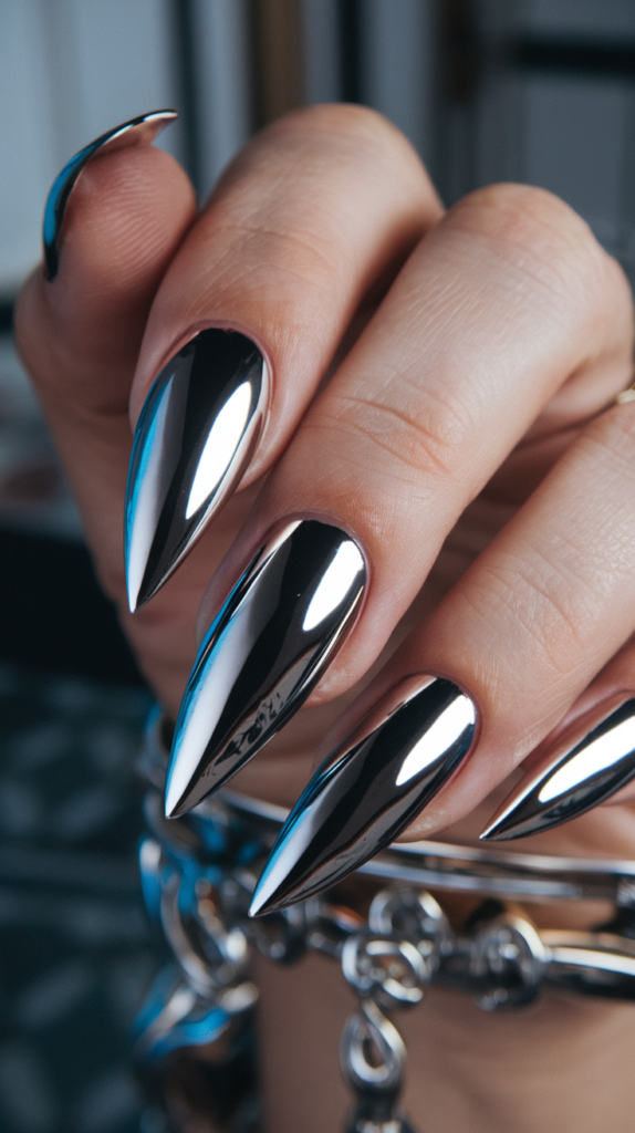 Long, stiletto-shaped nails with a reflective chrome finish for a fierce, high-fashion look