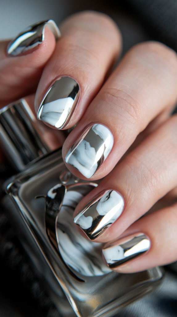 Textured chrome foil accents on nude nails creating a dimensional, reflective effect.

