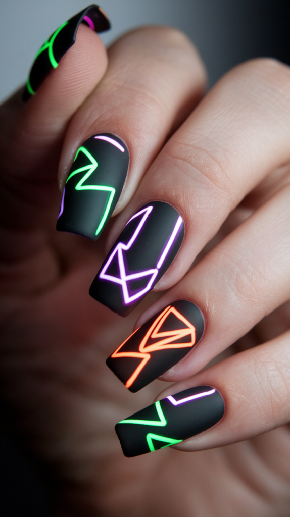 Neon geometric nail art featuring triangles and zigzags on a matte black base