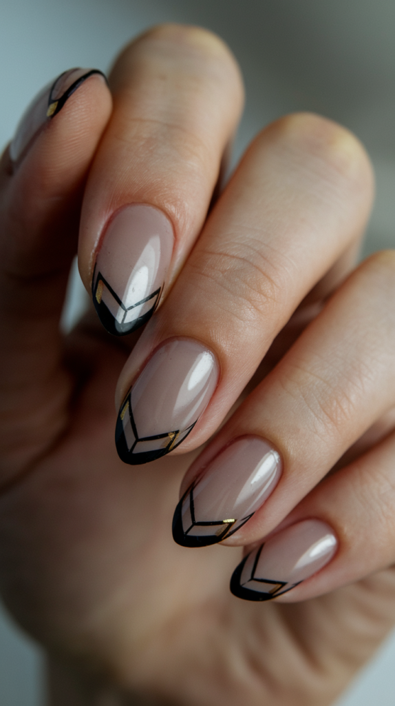 Clear nails with bold black and gold geometric tips, offering a minimalist yet striking Art Deco-inspired manicure.
