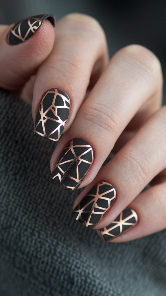 Matte black nails with metallic rose gold geometric patterns, blending bold textures for a chic Art Deco-inspired design.
