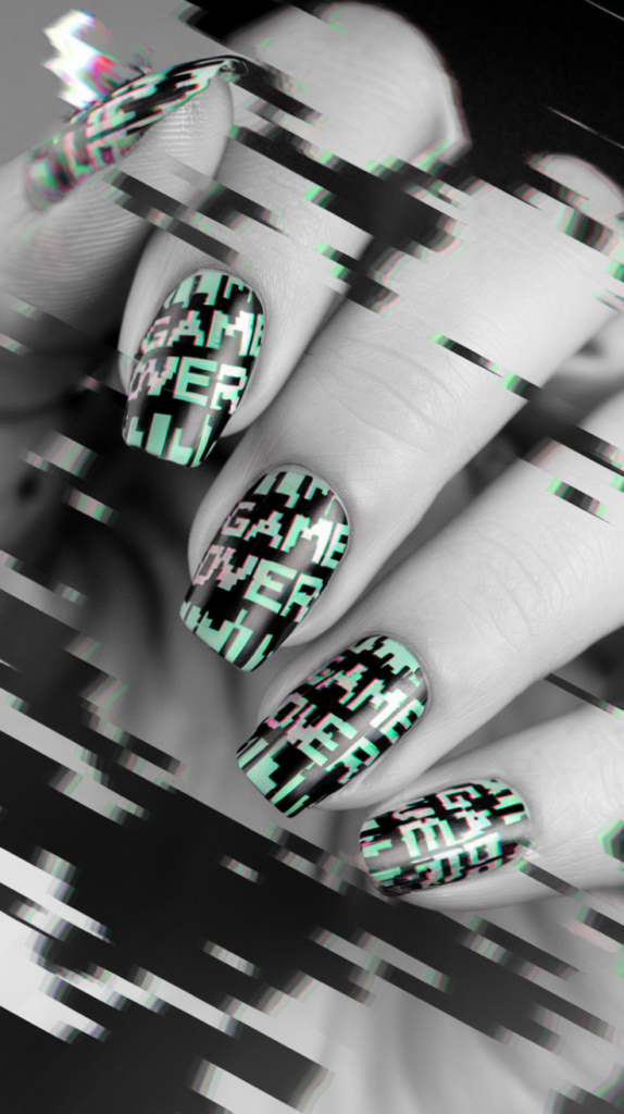 Glitch-inspired nail art with pixelated 'Game Over' text and broken, neon lines on a black and white background