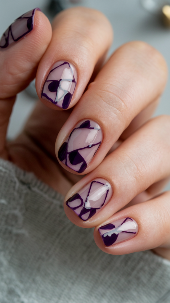 Minimalist nails with negative space designs in violet, leaving portions of the nail bare for a modern effect.

