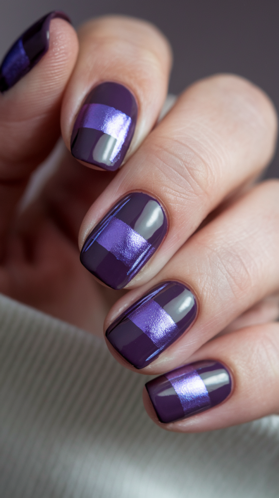 A sleek and modern violet nail with metallic accents in silver and chrome violet, creating stripes and geometric shapes.