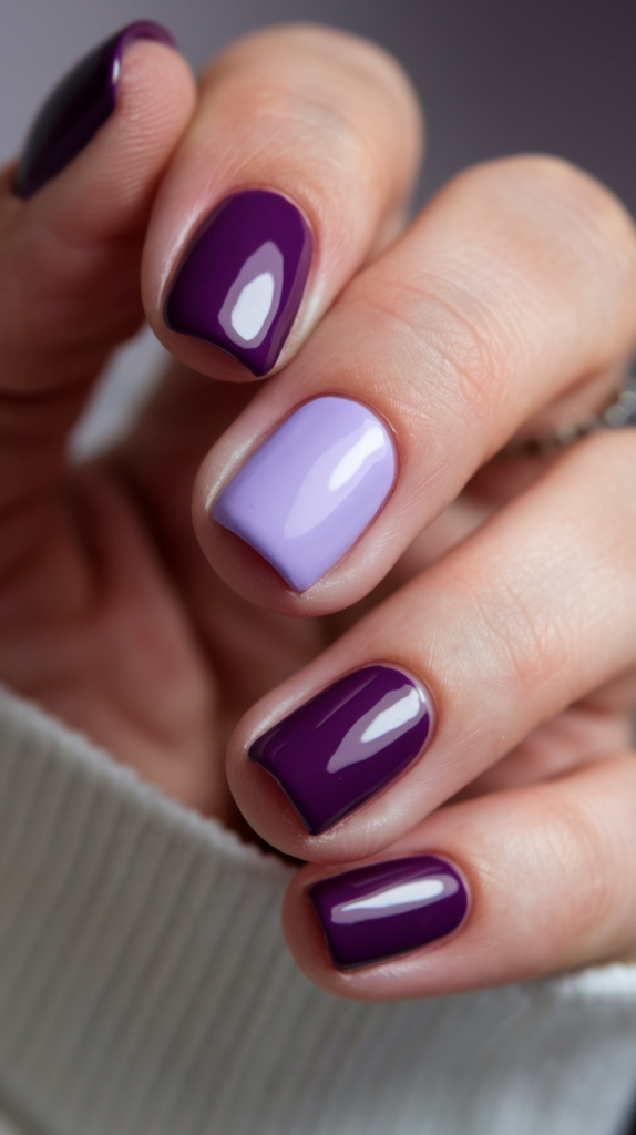 Nails alternating between shiny deep violet and matte lavender finishes, creating a striking contrast.

