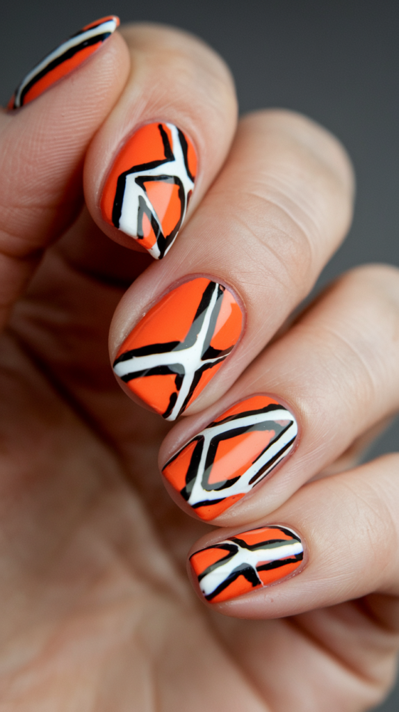 Tiny orange dots on a nude base for a modern, minimalist nail design.
