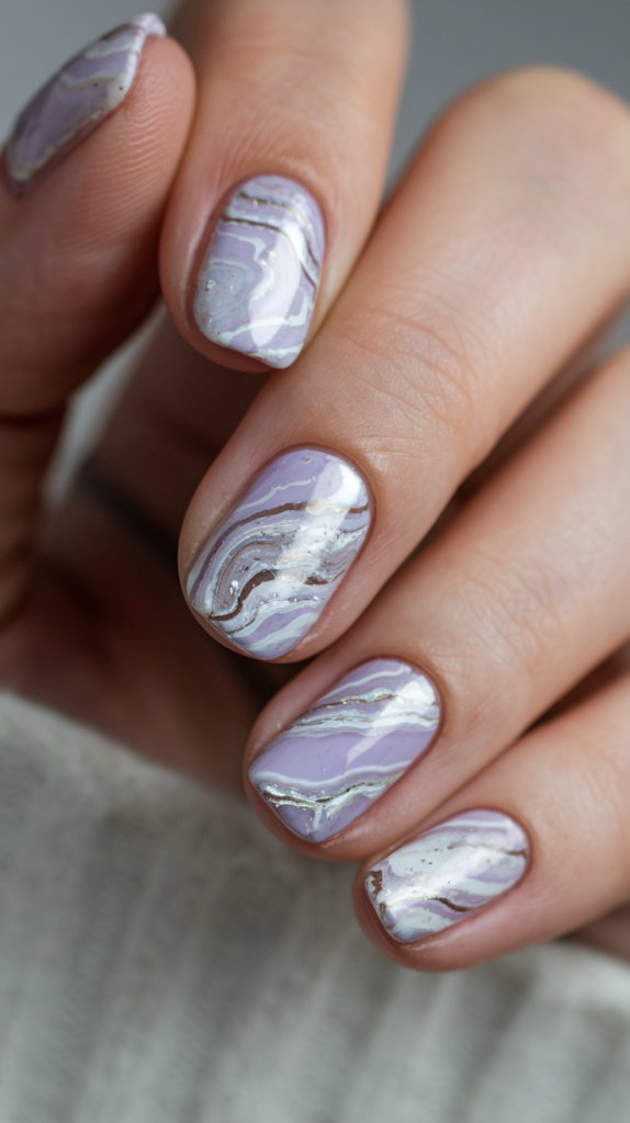 Nails designed to resemble lavender quartz stones with a blend of violet, white, and silver, creating a natural stone effect.

