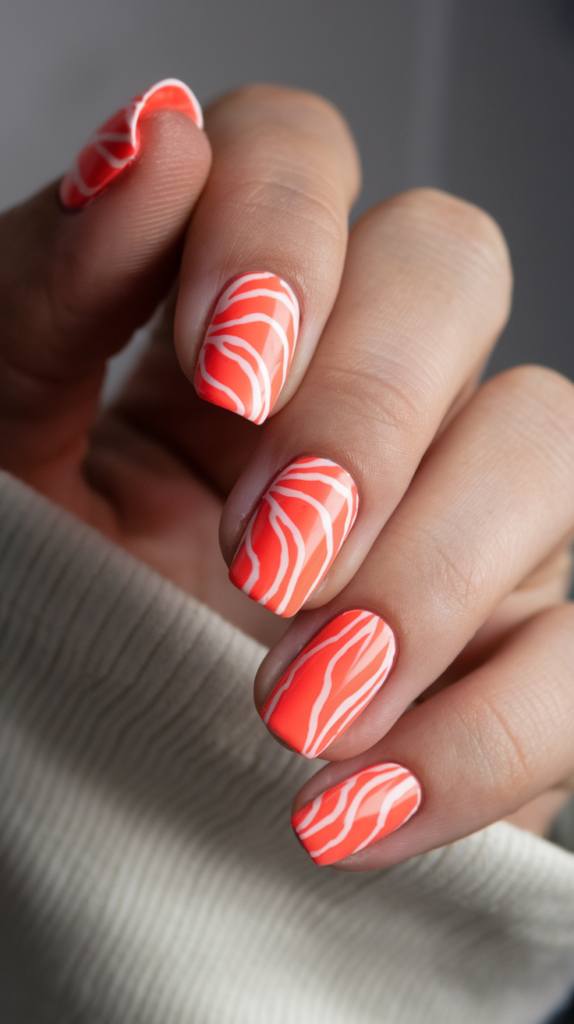 Neon Orange Nail Art with White Accents: Bright neon orange nails with sharp white lines creating a modern, electrifying style.
