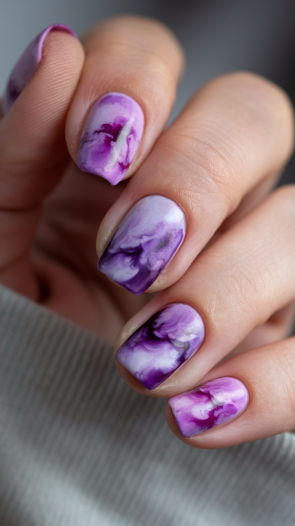 Swirling tie-dye pattern in various shades of violet, creating a vibrant, artsy look with smooth color transitions.

