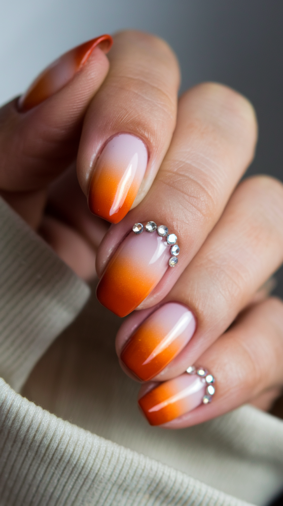 Orange nails with coral-inspired patterns, seashells, and bubble details.
