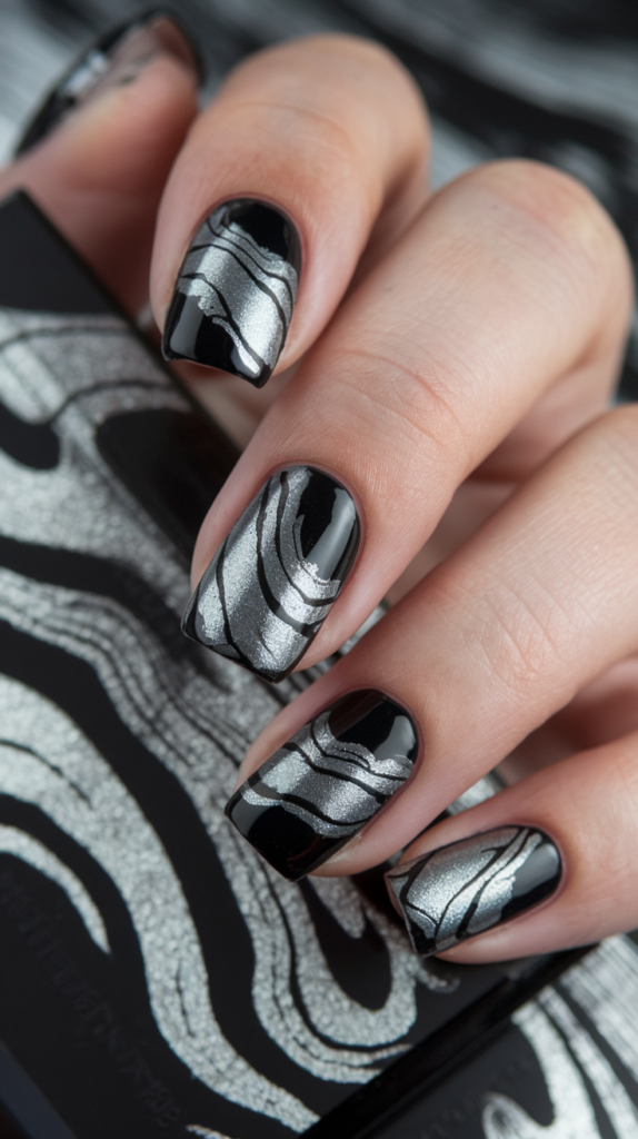 Clear nails featuring pieces of crinkled silver foil for a chic, shattered glass design.