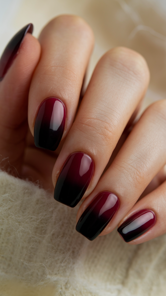 Rich burgundy to black gradient nails with a sleek glossy finish.