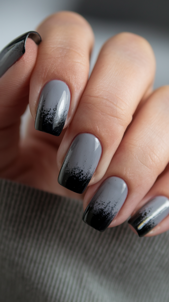 Charcoal gray to black gradient nails with a velvety matte finish.